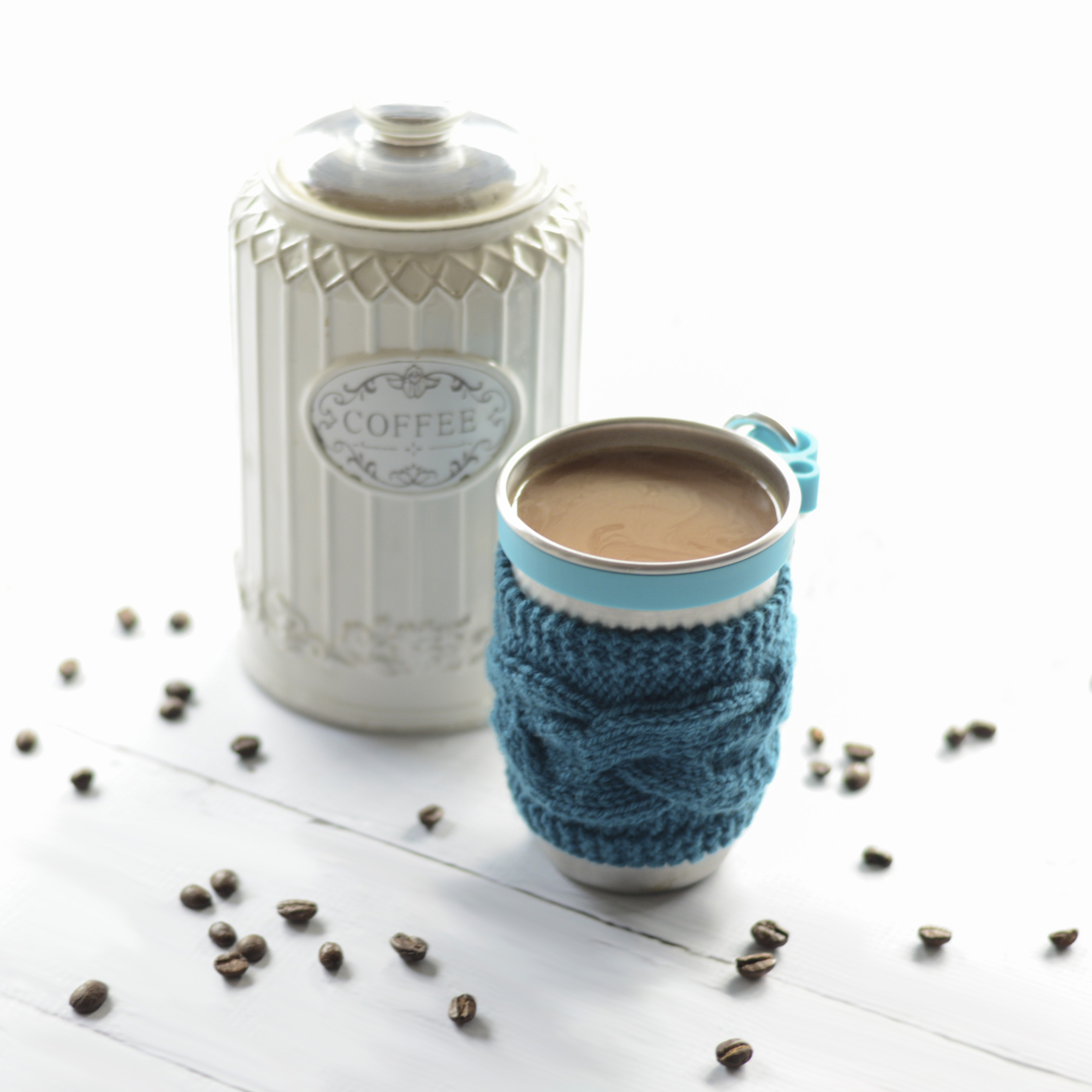 steel cup with crocheted coffee cups cozy