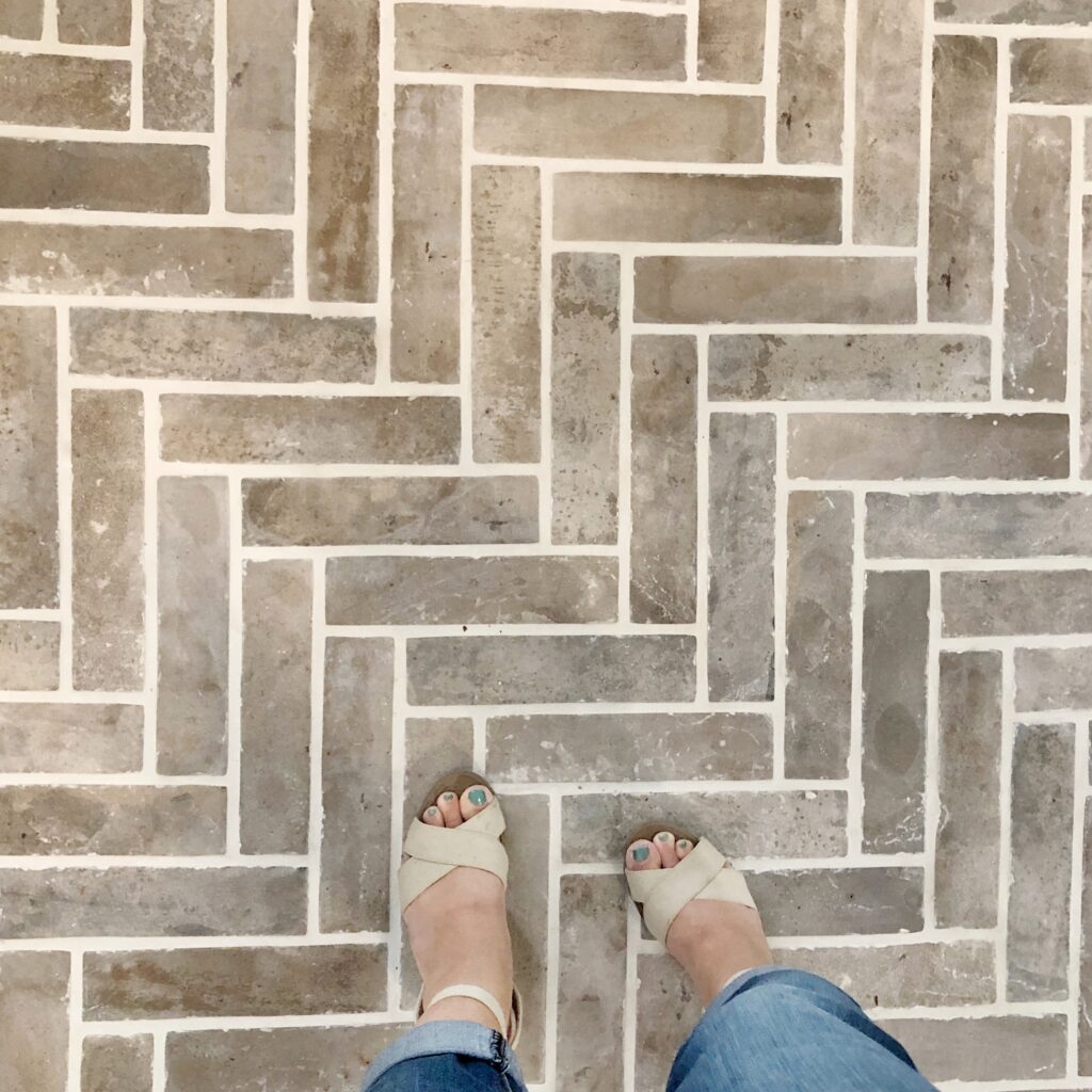 Tile flooring that looks like brick in a herringbone pattern