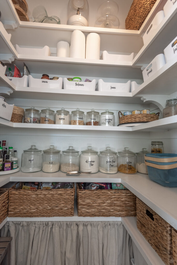 Baskets hide messy looking food items in this organized pantry