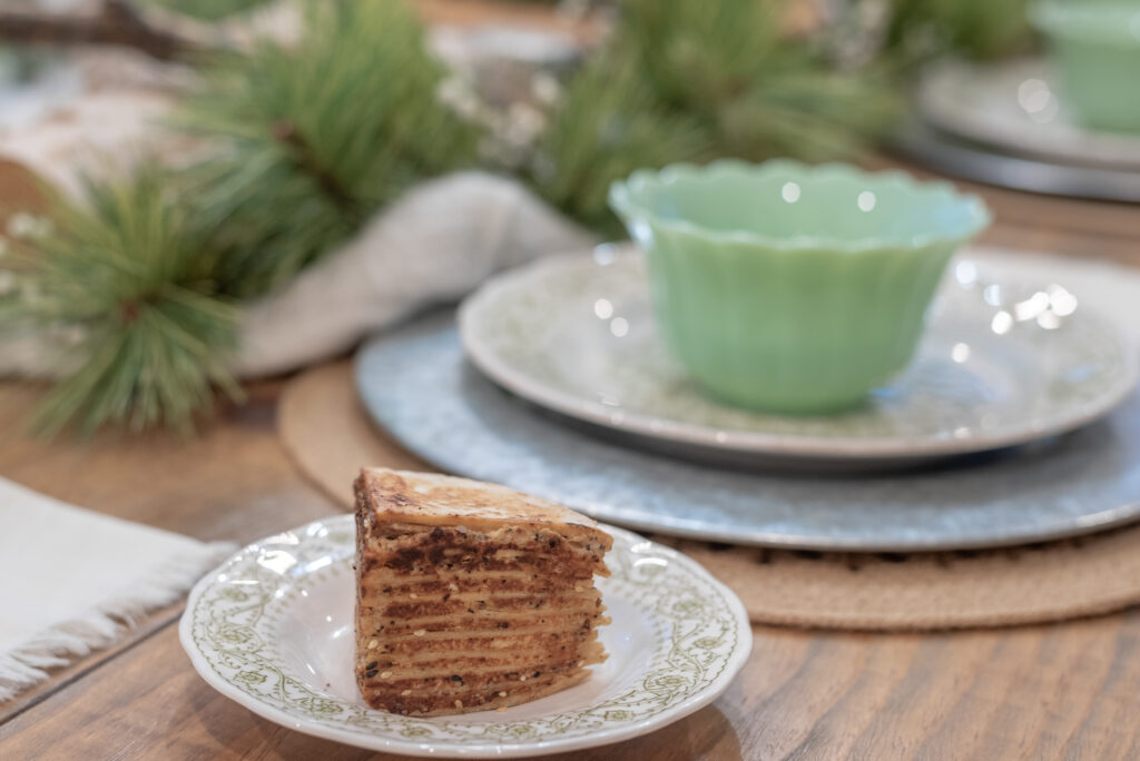 low carb Tortilla Cake looks delicious sitting on a cozy winter table next to a warm bowl of soup.