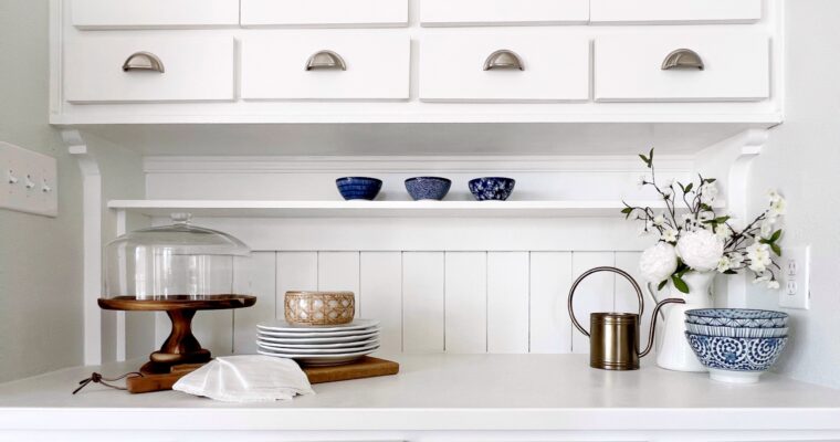 raising cabinets adds function and space to this white kitchen