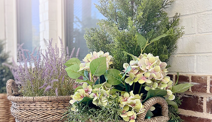 two basket planters filled to complement each other with lavender, hydrangeas, and rosemary.
