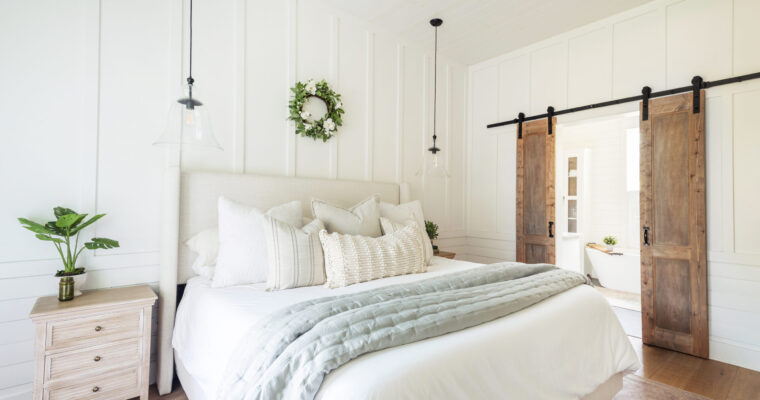 neutral bedroom with a white base, and creams, and grays with wood accents.